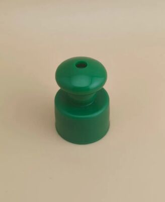 Tapa lisa de plástico verde con botón para botellas cosméticas