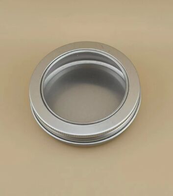 Gran caja de aluminio plateado con tapa de tornillo transparente para cosméticos